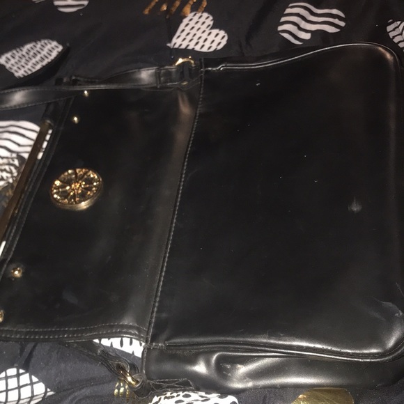 Black with gold tone hardware and faux leopard fur accents. Purse - Picture 3 of 5